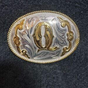 Gold and Silver Oval Belt Buckle with the initial “Q”